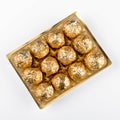 Chocolate pralines wrapped in gold foil Royalty Free Stock Photo