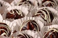 Chocolate profiterole with cream on wooden table