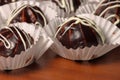 Chocolate profiterole with cream on wooden table