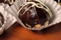 Chocolate profiterole with cream on wooden table
