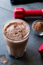 Chocolate Protein Shake Smoothie with Whey Protein Powder and Red Dumbbells Royalty Free Stock Photo