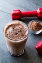 Chocolate Protein Shake Smoothie with Whey Protein Powder and Red Dumbbells