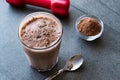 Chocolate Protein Shake Smoothie with Whey Protein Powder and Red Dumbbells Royalty Free Stock Photo