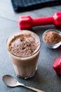 Chocolate Protein Shake Smoothie with Whey Protein Powder and Red Dumbbells Royalty Free Stock Photo
