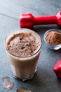 Chocolate Protein Shake Smoothie with Whey Protein Powder and Red Dumbbells Royalty Free Stock Photo