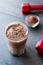 Chocolate Protein Shake Smoothie with Whey Protein Powder and Red Dumbbells Royalty Free Stock Photo