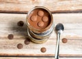 Chocolate pudding with chocolate buttons on a wooden background