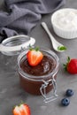 Chocolate pudding with fresh berries and whipped cream in a glass jar on a gray concrete background. Copy space Royalty Free Stock Photo