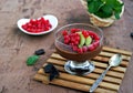 Chocolate pudding with red currants and kiwi in a glass ice-cream bowl Royalty Free Stock Photo