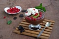 Chocolate pudding with red currants and kiwi in a glass ice-cream bowl Royalty Free Stock Photo