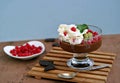 Chocolate pudding with red currants and kiwi in a glass ice-cream bowl Royalty Free Stock Photo