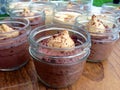 Chocolate puddings in single-serve Mason jars on outdoor table Royalty Free Stock Photo