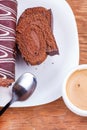 Chocolate roll with a cup of coffee close-up Royalty Free Stock Photo