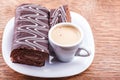 Chocolate roll with a cup of coffee Royalty Free Stock Photo