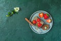 Chocolate rollcake with fresh strawberries in ceramic plate