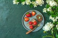 Chocolate rollcake with fresh strawberries in ceramic plate