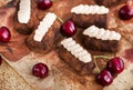 Chocolate rum balls cakes decorated with cream and fresh cherry Royalty Free Stock Photo