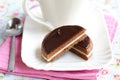 Chocolate sandwich biscuit halved, served with cof