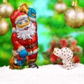 Chocolate Santa Claus in the snow with the dog. Royalty Free Stock Photo