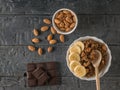 Chocolate, scattered almonds and quinoa porridge on a wooden table. Flat lay.