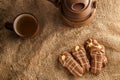 Chocolate shortbread biscuits with teaspot and cup of tea on canvas.