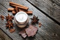 Chocolate skin treatment. Cosmetic jar with lotion, cocoa, anise, cinnamon sticks.