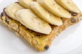 Chocolate and sliced banana on open wholewheat sandwich bread to Royalty Free Stock Photo