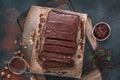 Chocolate slices with hazelnuts on rustic surface