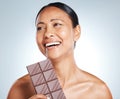 Chocolate, smile and senior woman thinking of health isolated on a blue background in studio. Food, happy and face of an Royalty Free Stock Photo