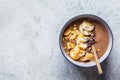 Chocolate smoothie bowl with banana, coconut and chocolate in a gray bowl, top view Royalty Free Stock Photo