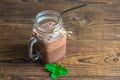 Chocolate smoothie, cocktail, almond milk and cream drink in a glass jar with a reusable iron straw and mint leaves on a wooden Royalty Free Stock Photo