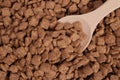 Chocolate snacks, dry breakfast, pillows in a wooden spoon Royalty Free Stock Photo