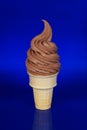 Chocolate Soft Serve Ice Cream on a Blue Background Royalty Free Stock Photo