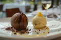 Chocolate Sphere, Passionfruit coulis cascades down, vanilla ice cream rests beside it