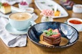 Chocolate sponge cake, with caramel, decorated with strawberries and mint leaf. Breakfast in the cafe, morning coffee Royalty Free Stock Photo