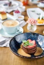 Chocolate sponge cake, with caramel, decorated with strawberries and mint leaf. Breakfast in the cafe, morning coffee Royalty Free Stock Photo