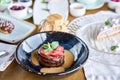 Chocolate sponge cake, with caramel, decorated with strawberries and mint leaf. Breakfast in the cafe, morning coffee Royalty Free Stock Photo