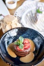 Chocolate sponge cake, with caramel, decorated with strawberries and mint leaf. Breakfast in the cafe, morning coffee Royalty Free Stock Photo