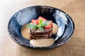 Chocolate sponge cake, with caramel, decorated with strawberries and mint leaf. Breakfast in the cafe, morning coffee Royalty Free Stock Photo