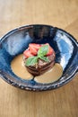 Chocolate sponge cake, with caramel, decorated with strawberries and mint leaf. Breakfast in the cafe, morning coffee Royalty Free Stock Photo