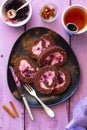 Chocolate sponge cake roulade with berry mousse on a plate