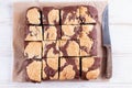 Chocolate spongy brownie cakes with cookies - Brookies on parchment paper. Flat lay