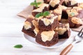 Chocolate spongy brownie cakes with cookies - Brookies in a white plate. Trend dessert