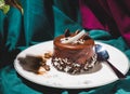 Chocolate spongy brownie cakes with walnuts and melted chocolate topping on a stack