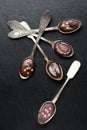 Chocolate spoons on dark background