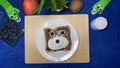 Chocolate spread on the bread decorated as a teddy bear. Creative kids breakfast Royalty Free Stock Photo