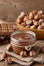 Chocolate spread with hazelnuts on wooden background Royalty Free Stock Photo