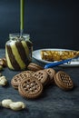 Chocolate spread or nougat cream with hazelnuts in a glass jar on a dark wooden background Royalty Free Stock Photo