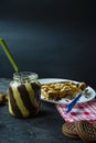 Chocolate spread or nougat cream with hazelnuts in a glass jar on a dark wooden background Royalty Free Stock Photo