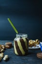 Chocolate spread or nougat cream with hazelnuts in a glass jar on a dark wooden background Royalty Free Stock Photo